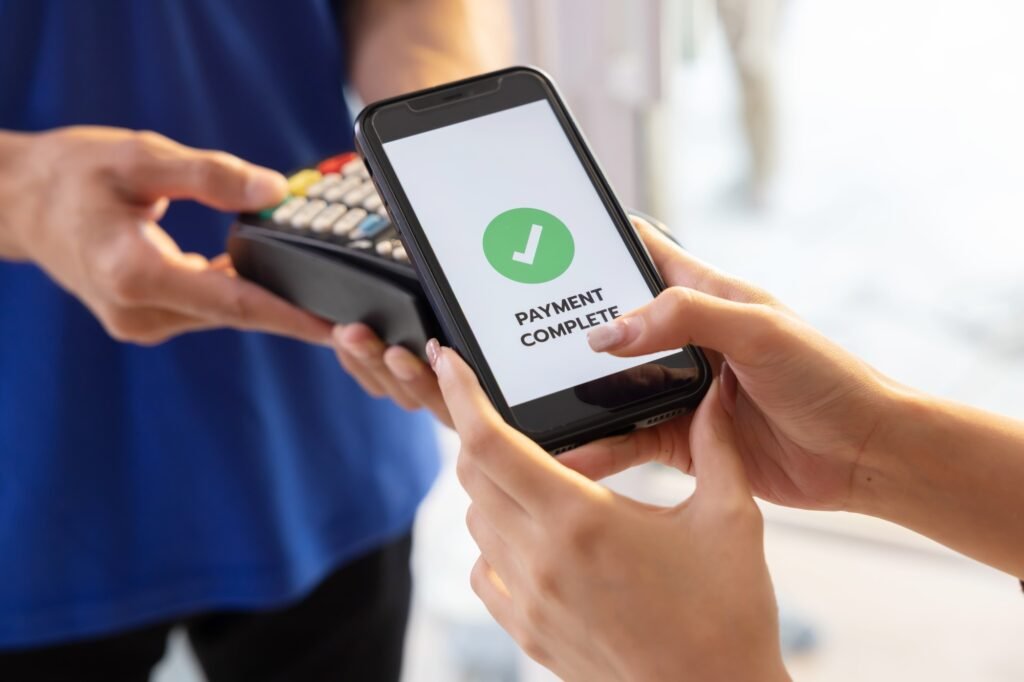 Woman Using Phone Payment to Transfer Money to Shop Seller